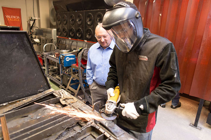 Michael Kepner, Director of Advanced Manufacturing Programs, supervising hands-on training to a studen