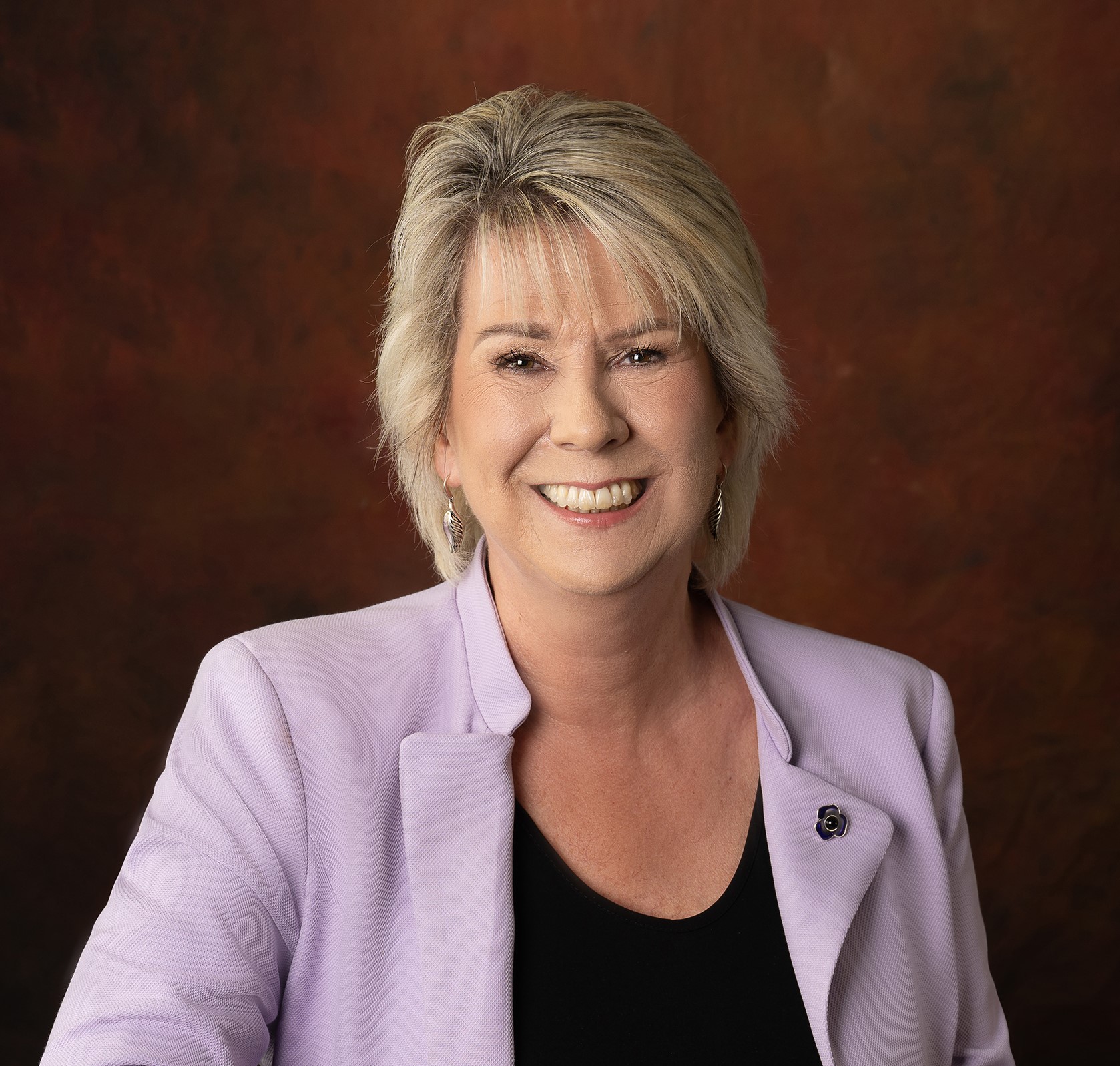 Photo of smiling female wearing professional attire