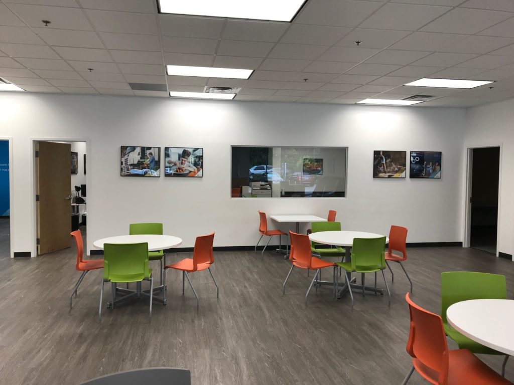 circle tables with orange and green chairs surrounding 