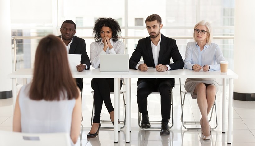 Top Interview Questions, Tips & Answers; group of professionals sitting at table