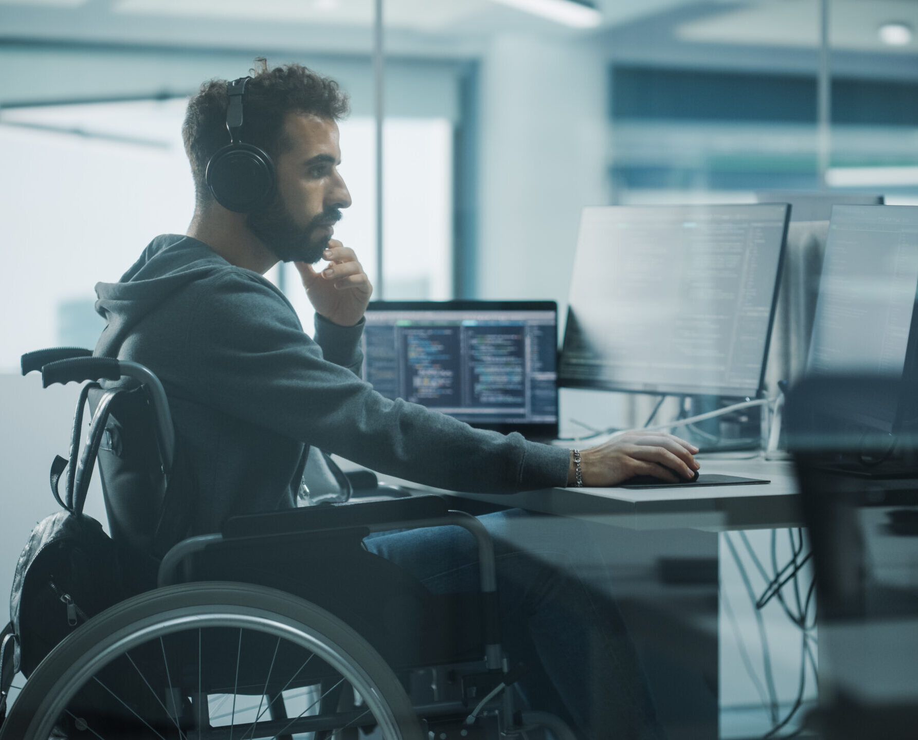 Programmer in a Wheelchair Working on Desktop Compute